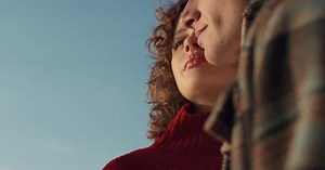 Young Couple Embracing Outdoors in Natural Light