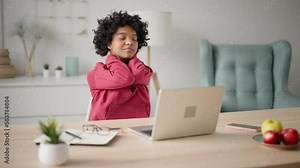 Tired business woman sits chair at table in home office doing warm up, stretches, massages neck in pain rubs tense muscles after long hard freelance work at computer laptop. Concept sedentary work. Stock-Video
