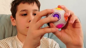 Serious Child Studies Fidget Puzzle Sphere Stock Footage Video (100% Royalty-free) 3993941099 | Shutterstock