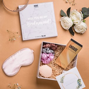 Hey brides-to-be! Love your girl gang? Give them the perfect surprise and say thank you for always having your back - the best way with his Bridesmaid Proposal Box! This box of awesomeness consists of a bunch of cutesy things that your girls will absolutely love. From scrunchies to candles, eye masks and the Click & Brush Perfume Pen from ITC Engage. Click on the link below to buy the box now! Buy here: https://lbb.in/shop/product/bridesmaid-proposal-box | LBB, Mumbai