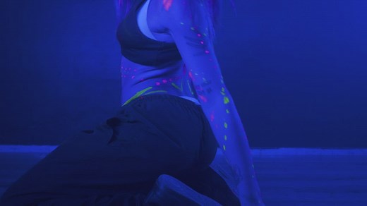 Young woman dancing with a mask under a party light - Free Stock Video