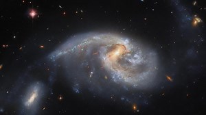 Panning over Interacting Galaxies NGC 5996 & NGC 5994 (Arp 72) | Hubble FriendsofNASA.org: This image features Arp 72, a very selective galaxy group that only includes two interacting galaxies: NGC 5996 (the large spiral galaxy) and NGC 5994 (its smaller companion, in the lower left of the image). Both galaxies lie approximately 160 million light-years from Earth, and their cores are separated from each other by a distance of around 67 thousand light-years. Moreover, the distance between the gal