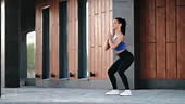 Strong fitness woman making squat exercises muscular sport person...