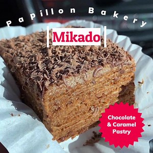 What better dessert to bring home for the family on Valentine's weekend than MIKADO?! Delicious chocolate and caramel layered pastry. 😋 Comes in half and full trays! Order now at www.papillonbakery.com | Papillon International Bakery