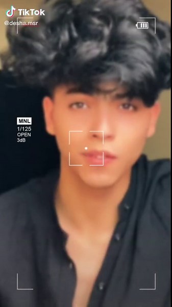 Dark Curly Hair Person in Black Shirt: Close-Up Shots