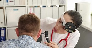 ENT doctor conducts medical examination with otoscope to patient. Hearing test in adults concept