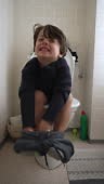 One Small Boy Sitting on Toilet in Bathroom, Childhood Potty Training...