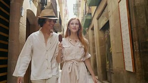 Smiling Couple Walking Old City Street Together. Cheerful Man Eating Icecream