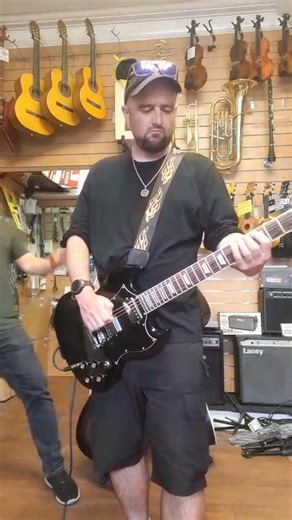 Quite coincidentally, this black SG copy has just arrived in stock this morning. Seemed fitting to channel some Sabbath vibes. Come and grab it and join in the doom laden riffs, yours for just £99.00. | Booth's Music