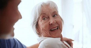 clip-3452949353-help-support-caregiver-senior-woman-nursing-home