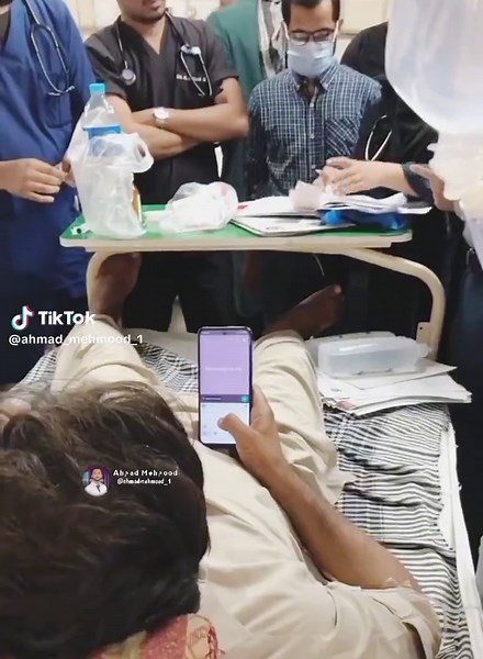 Consultant Doctor Rounds with Patient in Hospital