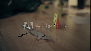 Bloody knife with crime scene marker on the floor, murder weapon, evidence