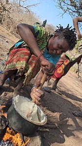 Beautiful Hadza women preparing traditional ugali in the nature, it is daily part of their natural diet | Dose Of Adventure