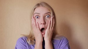 clip-3389825477-close-up-beautiful-woman-looking-camera-surprised-shocked