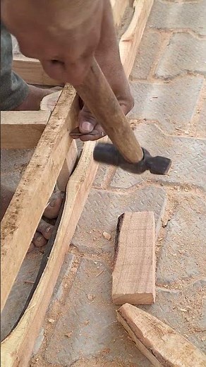 Male carpenter nail install in Wood with the help of Hammer