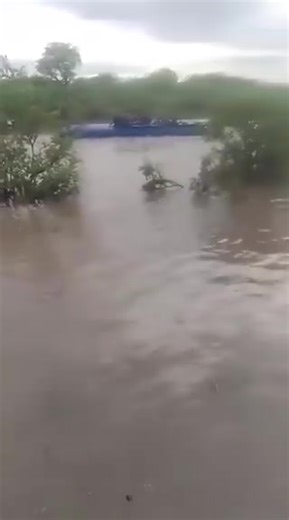 Do not cross flooded rivers! A Chivhu bus was swept off a bridge by strong floodwaters after the driver tried to cross following heavy rains. The bus is now almost completely underwater, and some passengers are sitting on top of it waiting for help — Crime Watch | Chiredzi Scrivener