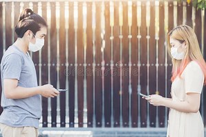 Young Asia Couple Using Smart Mobile Phote Outdoor Wearing Face Mask during Coronavirus Outbreak - Millennial Couple Watching Stock Photo - Image of cyberspace, cellphone: 207695334
