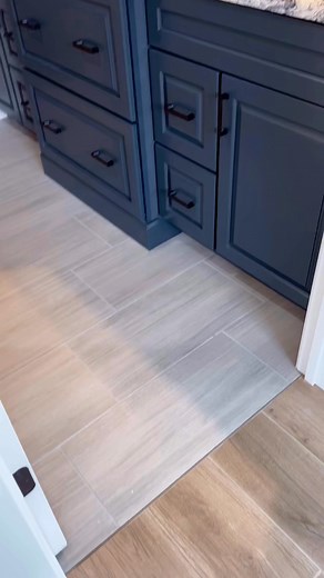 New construction barndominium tour continues! Welcome to the primary bathroom! 🤩 Homecrest cabinetry in Poolhouse Painted Finish, Cambria Quartz countertops in “Mayfair” design, Linear Porcelain 4” x 12” wall tile in shower with complimenting 1” x 3” herringbone mosaic shower floor tile. Tile floor is 12” x 24” porcelain tile in “Graylake” design. #masterbrandcabinets #homecrestcabinetry #cambriaquartz #cambriausa #barndominium #primarybathroom #tileshower #jbsdesignservices Lake Forest Builder