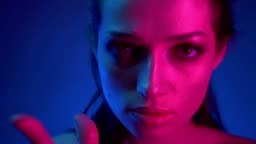 Close-up shoot of beautiful model in blue and pink neon lights...