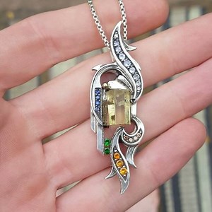 New fabricated pendant titled "Pyromancer" featuring a very clear heliodor with tanzanite, diamonds, garnets, tsavorite, and sapphire. This pendant is available. message me for price and details. | Mint Leaf Jewelry