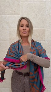 1.3M views · 6.6K reactions | Simple, stylish, and takes under 10 seconds! Fold the scarf into a triangle. Drape it over your arms, bring the ends forward, tie a loose knot in one end, and slip the other end through the loop. What do you think? Size 55"x55" #scarf #scarftutorial #silkscarf | Blonde Beach Vibes | Facebook