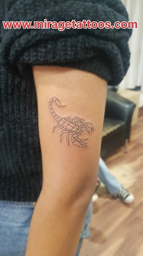 Symbolizing strength and resilience, this scorpion tattoo embodies...