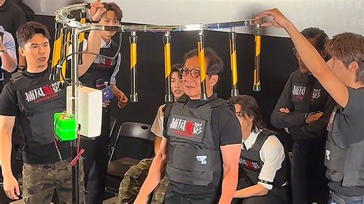 Jackie Chan takes on baton-catching reaction game