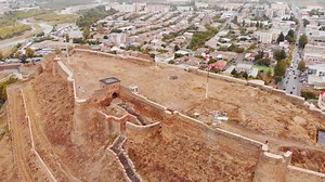 Download Aerial view down to Gori medieval castle architecture surrounded by autumn nature with Gori city panorama