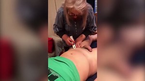 Woman Trimming and Shaving Male Client