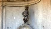 Manneken Pis statue in Brussels. Statue of a pissing boy in a...