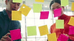 clip-1064020867-business-people-work-on-project-planning-board