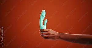 Sexual, toys and hand of woman with erotic pleasure and lubrication on studio background. Electric, product and sensual equipment wet with liquid for healthy stimulation and touching skin