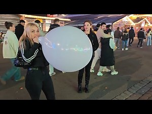 Girls blowing balloons at Volksfest (Preview)