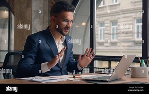 Arabian business man happy smiling guy office manager consultant male businessman greeting hello video call online meeting talking distant conference Stock Photo - Alamy