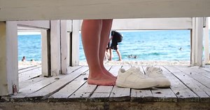 Woman in the Changing Dressing Room on the Beach at Sunset on the Seashore The Girl Changes Clothes