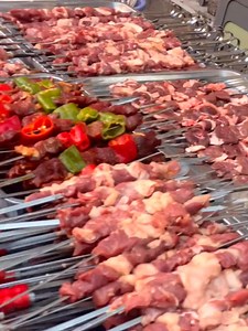 Cold-water fish fries to amber armor on an iron plate; lamb skewers burst with juice over charcoal. Noodles whip like chains between wok and spoon—just as hand-pulled rice fragrance spills over the table, bronze-pot mutton soup steams the snowy mountains into crimson. #XinjiangCuisine | This is Xinjiang