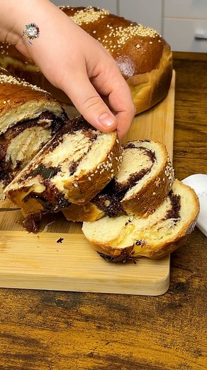 252K views · 4.5K reactions | Cozonaci pufoși cu maia și rahat. #cozonaci #retetesimple Hranire maia 25 gr maia 100gr faina 100gr apa Aluat 600 gr faina putina sare 250gr zahar 2 galbenusuri 1 ou intreg coaja de portocala si lamaie esenta de rom 80 gr unt Umplutura 250gr nuca de cocos 3 linguri cacao 4-5 linguri de zahar sucul de la o portocală rahat Extra: ou si lapte, susan | Ella Cooking | Facebook