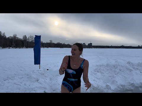 Girl swims in ice water for the first time. Water temperature 2 degrees Celsius