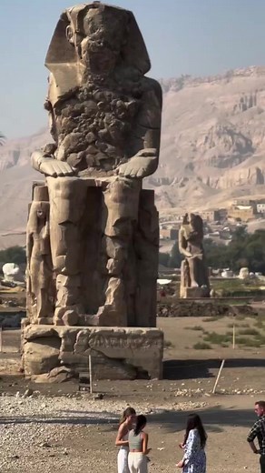 Colossi of Memnon West Bank Luxor 🇪🇬🇪🇬The Colossi of Memnon (also known as el-Colossat or el-Salamat) are two monumental statues representing Amenhotep III (1386-1353 BCE) of the 18th Dynasty of Egypt. They are located west of the modern city of Luxor and face east looking toward the Nile River. The statues depict the seated king on a throne ornamented with imagery of his mother, his wife, the god Hapy, and other symbolic engravings. The figures rise 60 ft (18 meters) high and weigh 720 tons