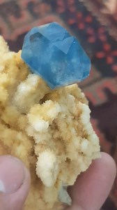 This striking celestine crystal is elegantly perched on a calcite matrix, boasting superb luster and exceptional clarity. Its sharp sky blue hue is vividly displayed, making it a standout piece. Sourced from Darai Laman, Badghis Province, Afghanistan. This specimen is a true gem. Ideal for collectors seeking natural beauty and geological significance. Crystal measures 3 x 2.3 cm | Artistic minerals