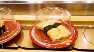 Conveyor belt sushi in Japanese restaurant, different sushi rolling on conveyer belt, Japan.