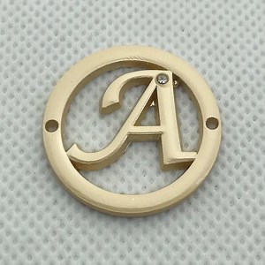 [Hot Item] Neostar Fashion Design Letter Cut out Brand Logo Custom Metal Label for Garments