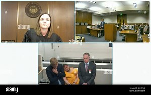 In this image from El Paso County District Court video, Anderson Lee Aldrich, 22, center of bottom screen, is slumped over in a chair during a brief video appearance from jail in Colorado Springs, Colo., Wednesday, Nov. 23, 2022. Aldrich, the alleged shooter is facing possible hate crime charges in the fatal shooting of five people at a Colorado Springs gay nightclub, was ordered held without bail in an initial court appearance Wednesday. At top left is El Paso County Court Judge Charlotte Anken