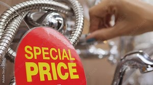 Shower Bath Faucets Shelf at Plumbing Store. Young Woman Looking for New Crane for Bathroom Shopping in Department Mall. Red Sale Special Price Tag Closeup. 4K.