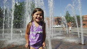 Girl playing in fountain
