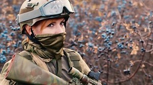 A woman soldier with a weapon