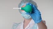 Close-up view of a female colorectal surgeon holds an enema or...
