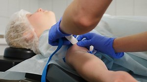 Female patient is under anesthesia in hospital. hand of patient under anesthesia during surgery. Medical procedure in operating room. Nurse injecting medicine, 4 k video