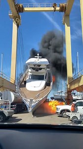 Crane Failure Causes Massive Shipyard Fire San Diego, California — July 12, 2025 A routine maintenance operation turned into a catastrophic scene at a local shipyard on Saturday morning. A luxury yacht was being transported by a heavy-duty gantry crane when mechanical failure led to a dramatic and dangerous accident that sent shockwaves through the marina. The video captures the terrifying moment a support sling unexpectedly snapped while the massive vessel was suspended high in the air. As the 