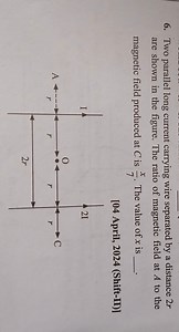 Two parallel long current-carrying wires are separated by a dis... | Filo